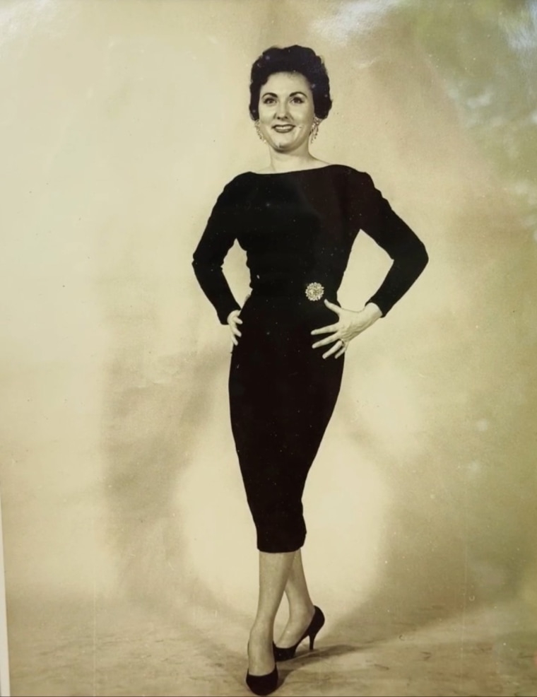 Young Ruth Lemay in a black dress posing as a model.
