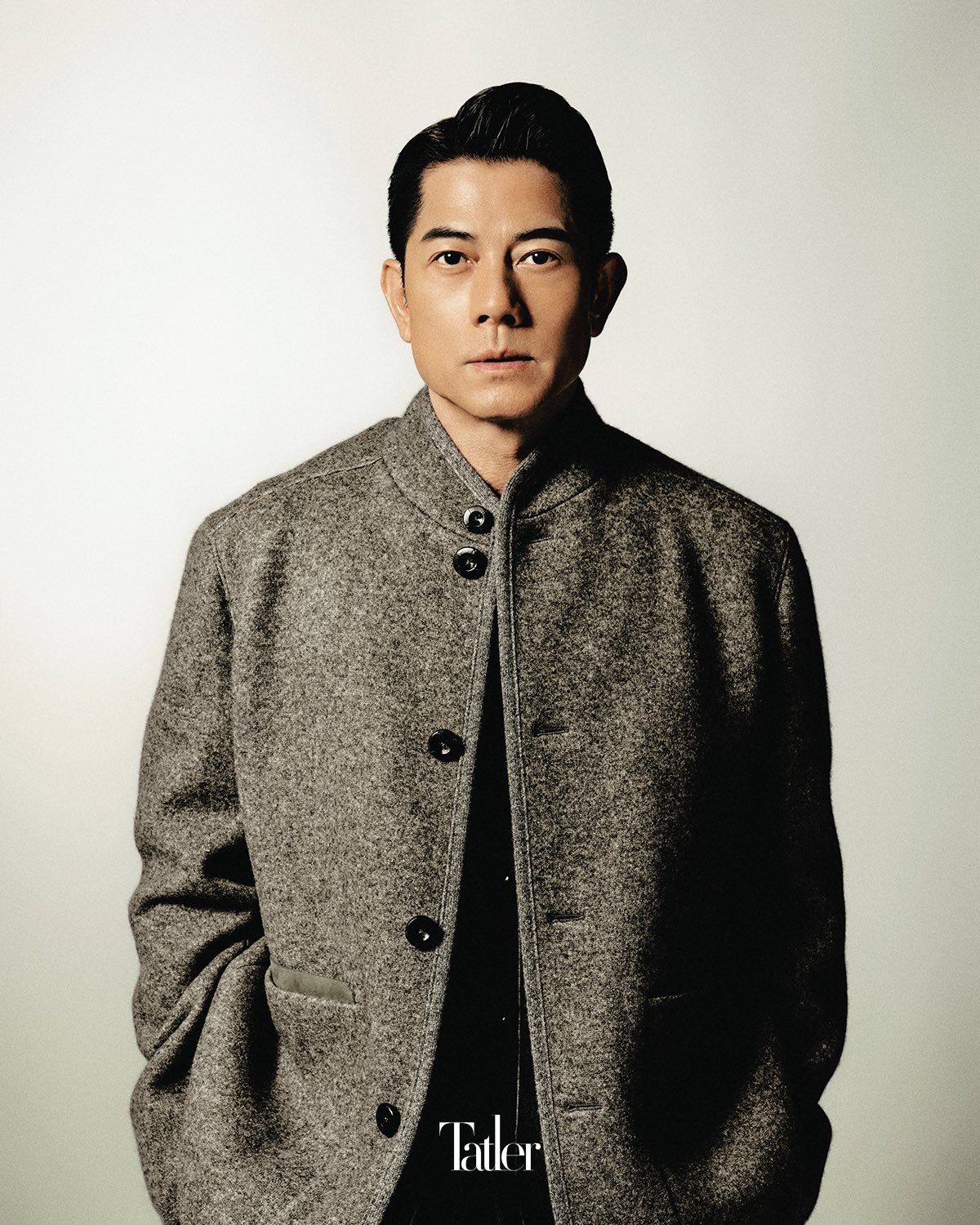 May be an image of 1 person, duffle coat, overcoat, suit and text that says 'Tatler'