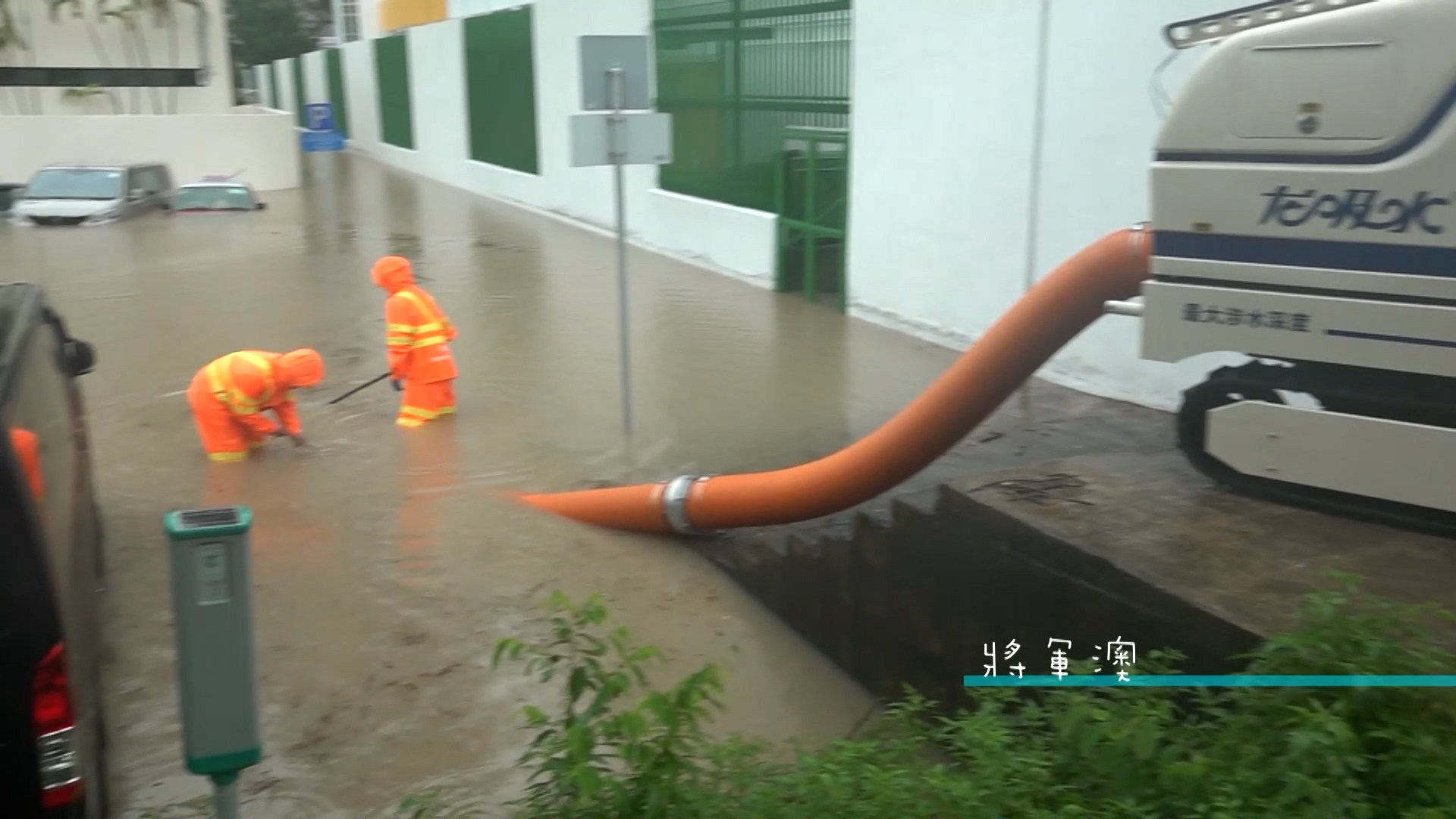 有渠務署外判工在現場以大型抽水機抽水。