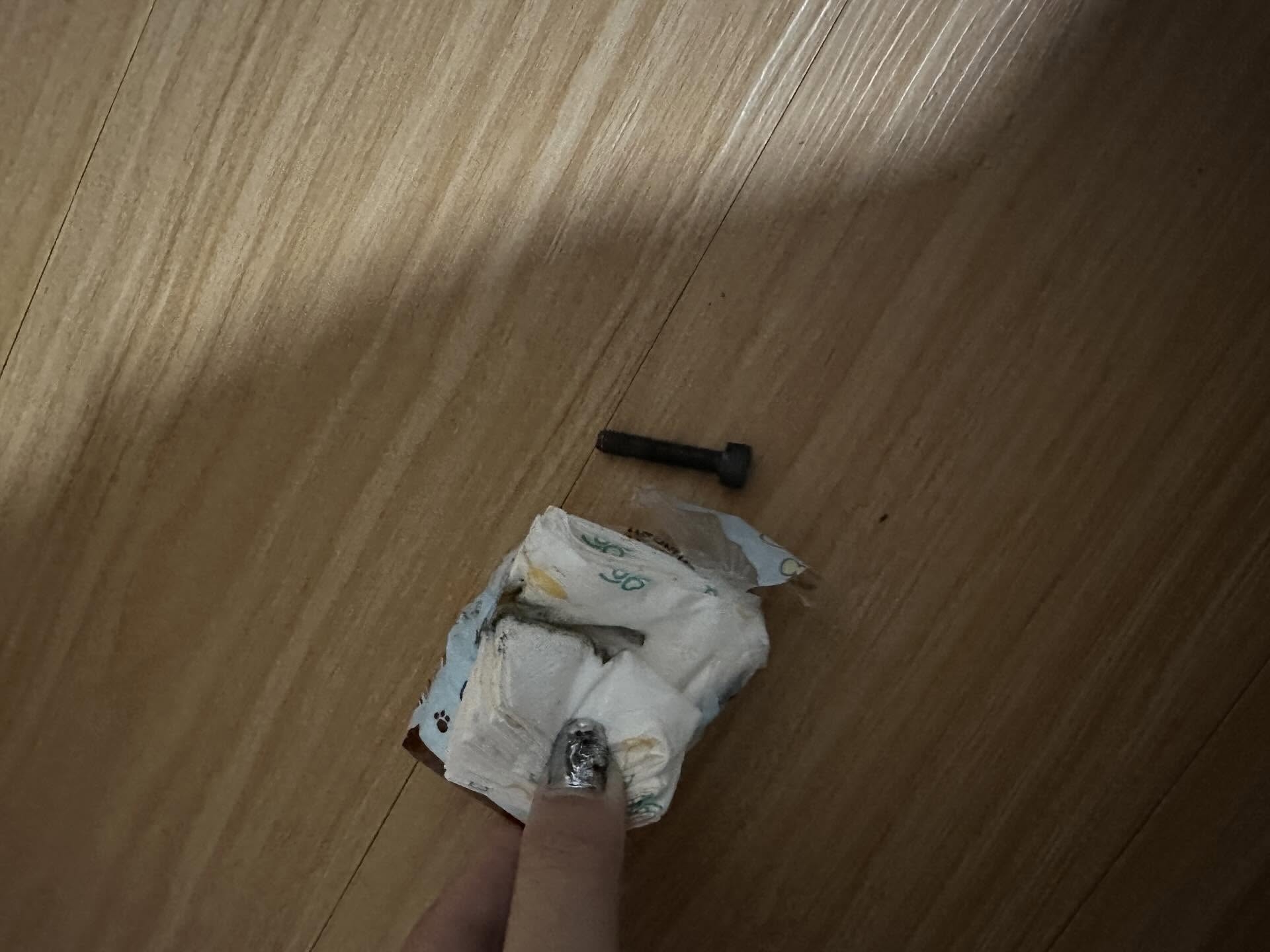 紙巾間夾有一枚金屬螺絲，表面顏色偏黑，疑似氧化生鏽。事主帖文形容：「摸落側邊硬硬地、仲要係黑色；一打開Ｘ街成粒鐵螺絲係入邊。」