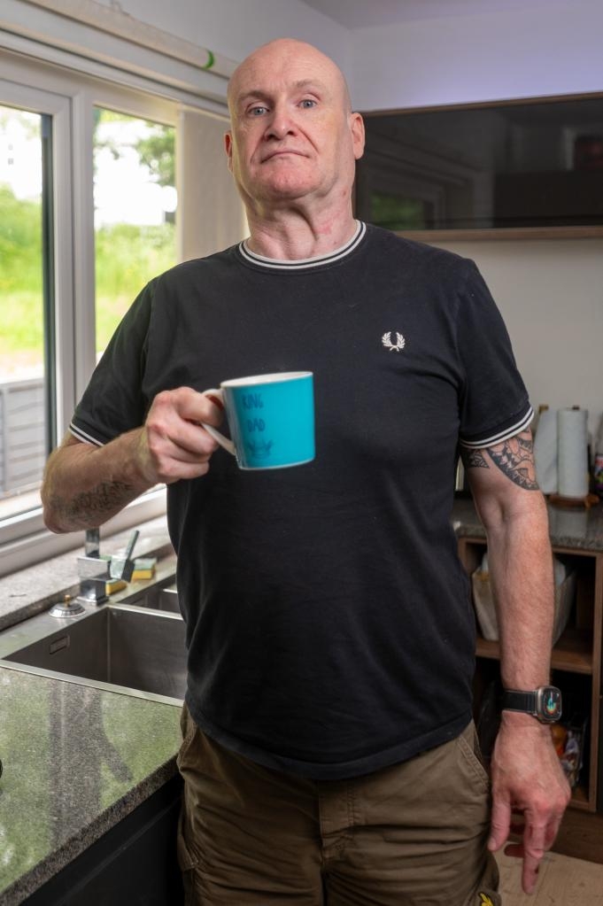 John Granahan holding a mug that says 