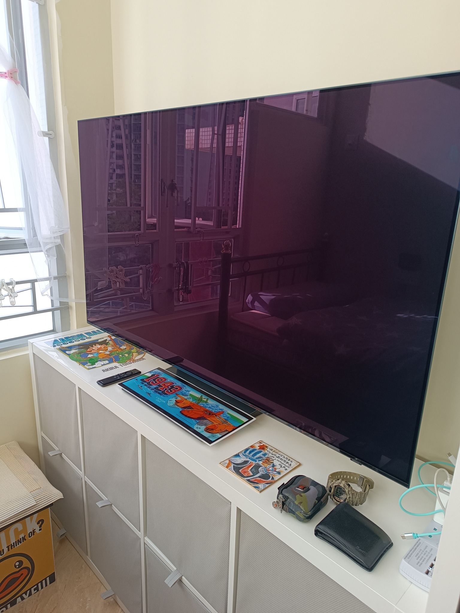 May be an image of controller, television and text